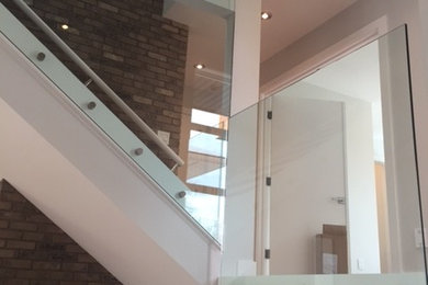 Staircase - mid-sized contemporary straight staircase idea in Calgary
