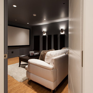Inspiration for a small contemporary enclosed home cinema in Vancouver with grey walls, cork flooring and a projector screen.