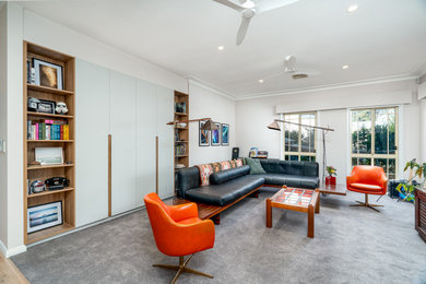Inspiration for a large eclectic family room in Sydney with a library and carpet.