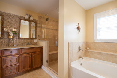 Large elegant master beige tile bathroom photo in New York with an undermount sink, recessed-panel cabinets, medium tone wood cabinets, granite countertops, a one-piece toilet and beige walls