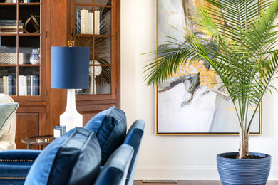 Example of a large transitional enclosed medium tone wood floor living room design in Boston with white walls, a stone fireplace and a wall-mounted tv