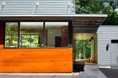 Example of a minimalist gray two-story wood exterior home design in New York