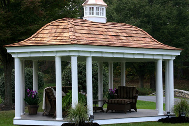 Large traditional backyard patio in Other with a gazebo/cabana.