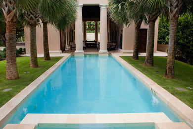 Inspiration for a large timeless backyard stone and rectangular lap hot tub remodel in Austin