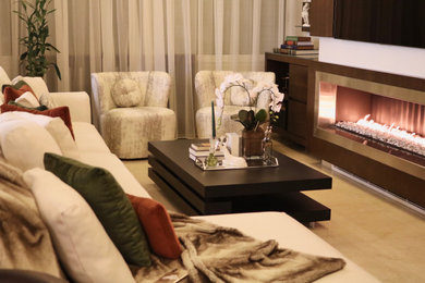 Inspiration for a mid-sized modern marble floor and beige floor living room remodel in Other with beige walls, a standard fireplace, a wood fireplace surround and a wall-mounted tv