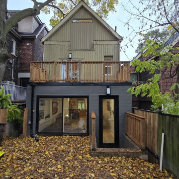 Roof deck with a cedar railing on top of a rear extension, Toronto