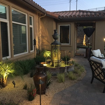 Tuscan lit fountain with bronze path lights and spot lights casting shadows