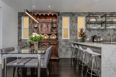 Eat-in kitchen - mid-sized eclectic u-shaped dark wood floor and brown floor eat-in kitchen idea in San Diego with an undermount sink, flat-panel cabinets, white cabinets, quartz countertops, ceramic backsplash, stainless steel appliances, a peninsula, white countertops and multicolored backsplash