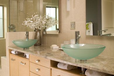Example of a trendy master beige tile and porcelain tile porcelain tile doorless shower design in San Francisco with a vessel sink, flat-panel cabinets, light wood cabinets, granite countertops and white walls