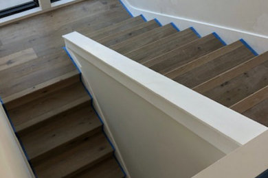 Minimalist wooden u-shaped staircase photo in San Francisco with wooden risers