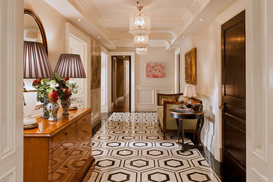 Example of a classic multicolored floor entry hall design in New York with white walls