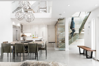 Inspiration for a contemporary concrete floor and gray floor dining room remodel in Vancouver with white walls