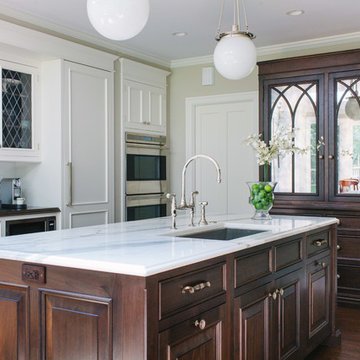 White cabinets with leaded glass, walnut island