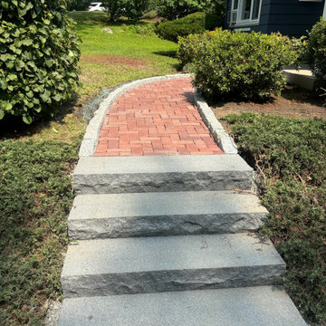 Monolithic blue mist granite steps with city hall bricks walkway