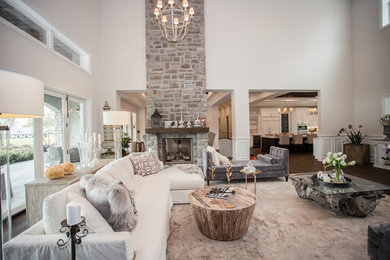 Inspiration for a large timeless formal and open concept dark wood floor living room remodel in Orlando with white walls, a two-sided fireplace, a stone fireplace and no tv