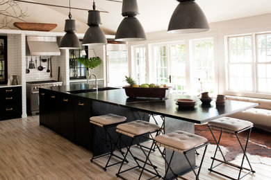 Inspiration for a beach style kitchen in New York with flat-panel cabinets, dark wood cabinets, soapstone benchtops and with island.
