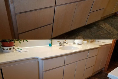 Inspiration for a small bathroom remodel in Portland with beige cabinets and brown walls
