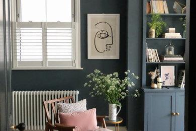 Mid-sized transitional formal and open concept light wood floor and wall paneling living room photo in London with blue walls, a standard fireplace and a tile fireplace