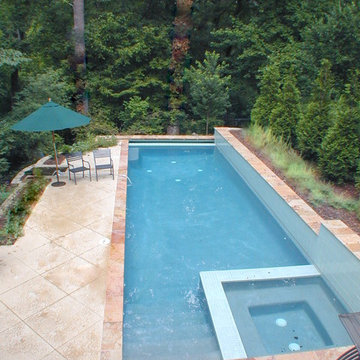 Lap pool fits on long skinny lot. Walls above and below pool make it work on hil