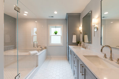 Inspiration for a large transitional master blue tile and subway tile porcelain tile, white floor, double-sink and wallpaper bathroom remodel in Chicago with shaker cabinets, blue cabinets, an undermount tub, a two-piece toilet, blue walls, an undermount sink, quartz countertops, a hinged shower door, white countertops and a built-in vanity