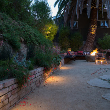 Custom wall lights in foreground and seating area with fire pit in background