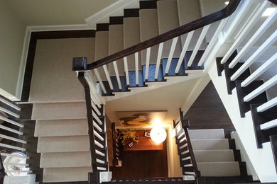 Mid-sized transitional wood l-shaped staircase in New York with painted wood risers.