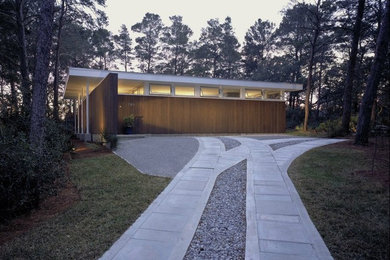 Photo of a small modern one-storey exterior in Miami with wood siding.