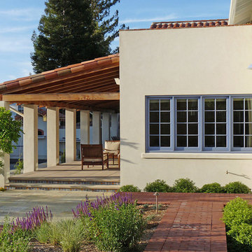 Mission style residential design with covered loggia opening to outdoor space