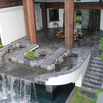 Backyard Patios and pool waterfall, water feature and fire pit in Florida