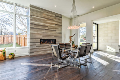 Great room - huge dark wood floor and brown floor great room idea in Austin with a ribbon fireplace, white walls and a tile fireplace