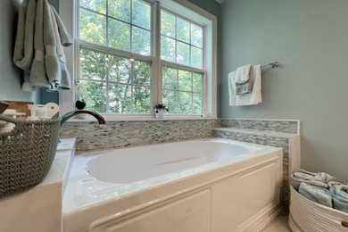 Bathroom - large coastal master white tile ceramic tile, gray floor and double-sink bathroom idea in New York with a built-in vanity, flat-panel cabinets, white cabinets, a two-piece toilet, green walls, an undermount sink, quartz countertops, a hinged shower door, white countertops and a niche