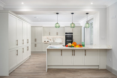 Inspiration for a large classic kitchen in Berkshire with shaker cabinets, onyx worktops and an island.