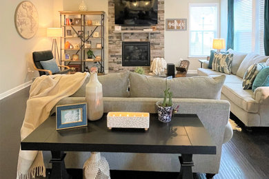 Photo of a large contemporary games room in Baltimore with grey walls, medium hardwood flooring, a standard fireplace and black floors.