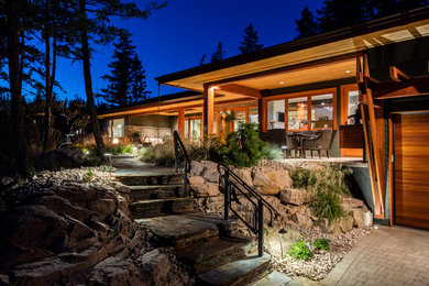 Mid-sized contemporary brown two-story mixed siding house exterior idea in Vancouver with a hip roof