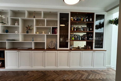 This is an example of a large traditional home bar in London.