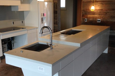 Inspiration for a large contemporary eat-in kitchen remodel in Baltimore with concrete countertops and an island