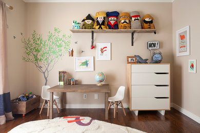 Example of a transitional gender-neutral dark wood floor kids' room design in Los Angeles with beige walls