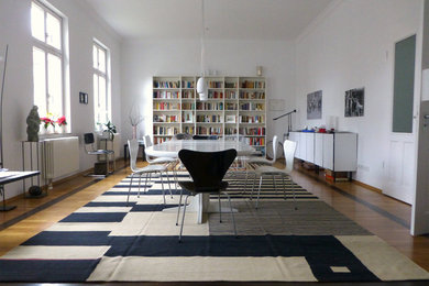 Mid-sized modern separate dining room in Berlin with white walls, carpet and no fireplace.