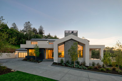 Inspiration for a modern white two-story stucco exterior home remodel in San Francisco with a metal roof and a black roof