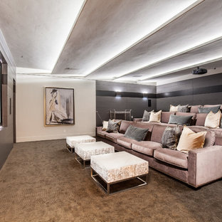 Design ideas for an expansive traditional enclosed home cinema in Las Vegas with multi-coloured walls, carpet, a projector screen and brown floors.