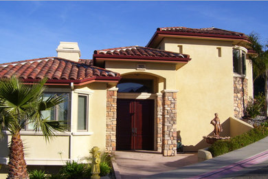 Inspiration for a mid-sized mediterranean yellow split-level stucco exterior home remodel in San Luis Obispo
