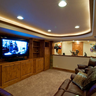 This is an example of an expansive rustic fully buried basement in Denver with yellow walls and carpet.