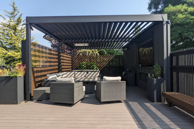 Inspiration for a small contemporary backyard ground level cable railing outdoor kitchen deck remodel in Seattle with a pergola