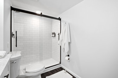 Alcove shower - 3/4 single-sink alcove shower idea in St Louis with a hinged shower door