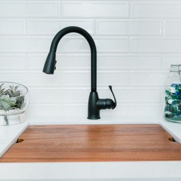 All-White Bathroom Sink with Matte Black Accented Faucet