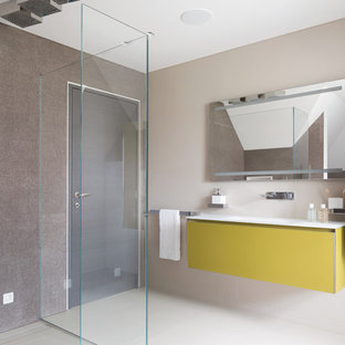 Inspiration for a contemporary shower room in London with flat-panel cabinets, yellow cabinets, a built-in shower, beige walls, an integrated sink, white floors and white worktops.