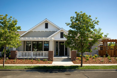 This is an example of a large transitional one-storey grey house exterior in Sacramento with wood siding, a gable roof and a shingle roof.