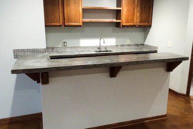 Basement - concrete floor basement idea in Omaha with white walls
