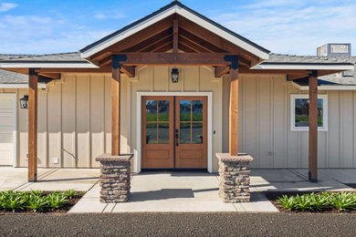 Mid-sized beige one-story mixed siding and board and batten exterior home idea in Other with a shingle roof and a gray roof