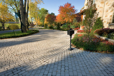 Inspiration for a mid-sized timeless beige two-story stone exterior home remodel in New York with a tile roof